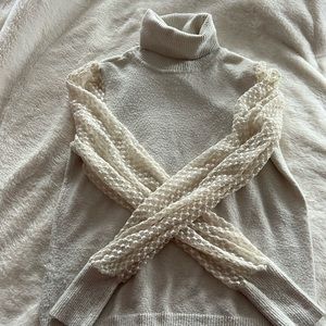 Cream turtleneck sweater with mesh patterned sleeves. Great for layering!